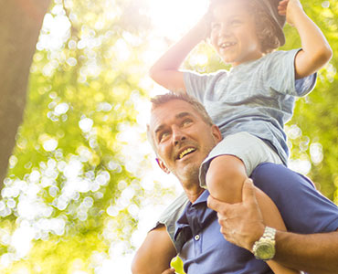 dad with son on shoulders