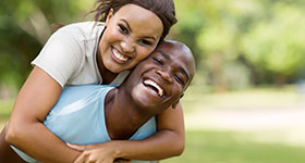 couple laughing while on a run