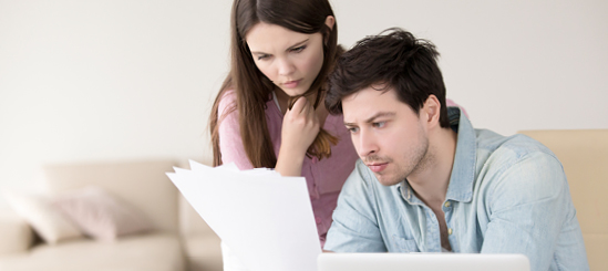 Couple reviewing paper