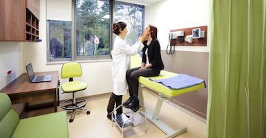 female doctor examining patient 385x200