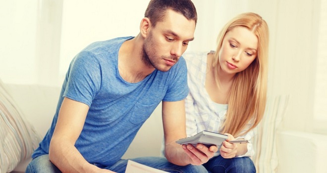 man and woman with calculator