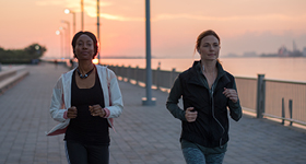 two women jogging at sunrise/sunset