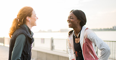 two woman runners laughing