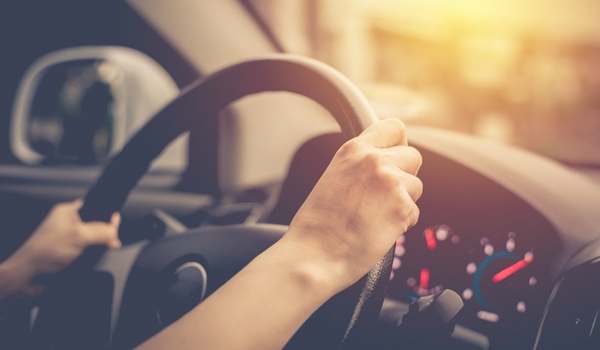 hands on steering wheel in car