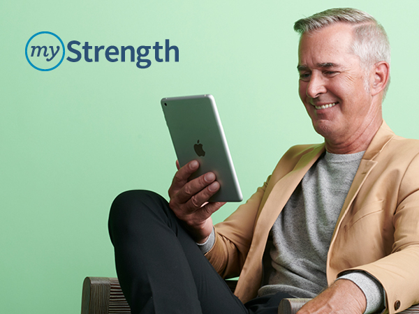 myStrength logo and smiling older man in a tan jacket looking at a tablet
