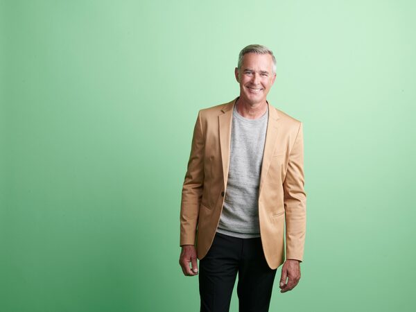 Gray-haired man wearing a tan blazer
