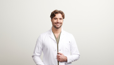 smiling man wearing lab coat