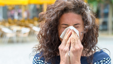 woman blowing nose
