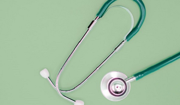 green stethoscope on green background