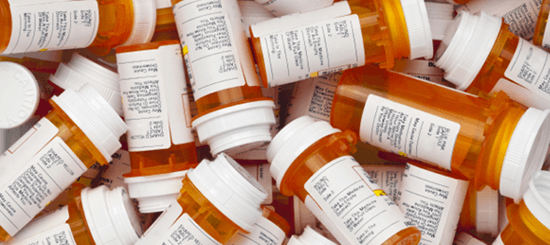pile of prescription bottles- 550x245