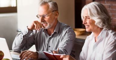 Elderly couple looking at computer