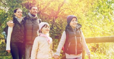 Family walking through park during the fall