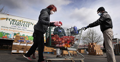 People filling shopping cart with food