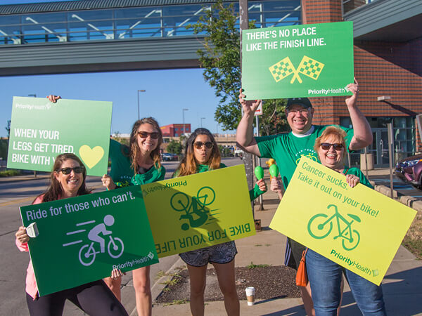 Priority Health Champions holding signs