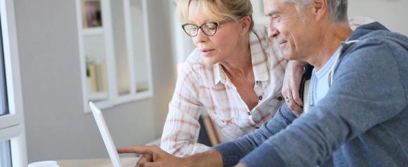 man and woman looking at laptop