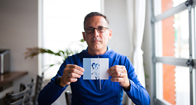 Champion Thomas Allen holding his artwork